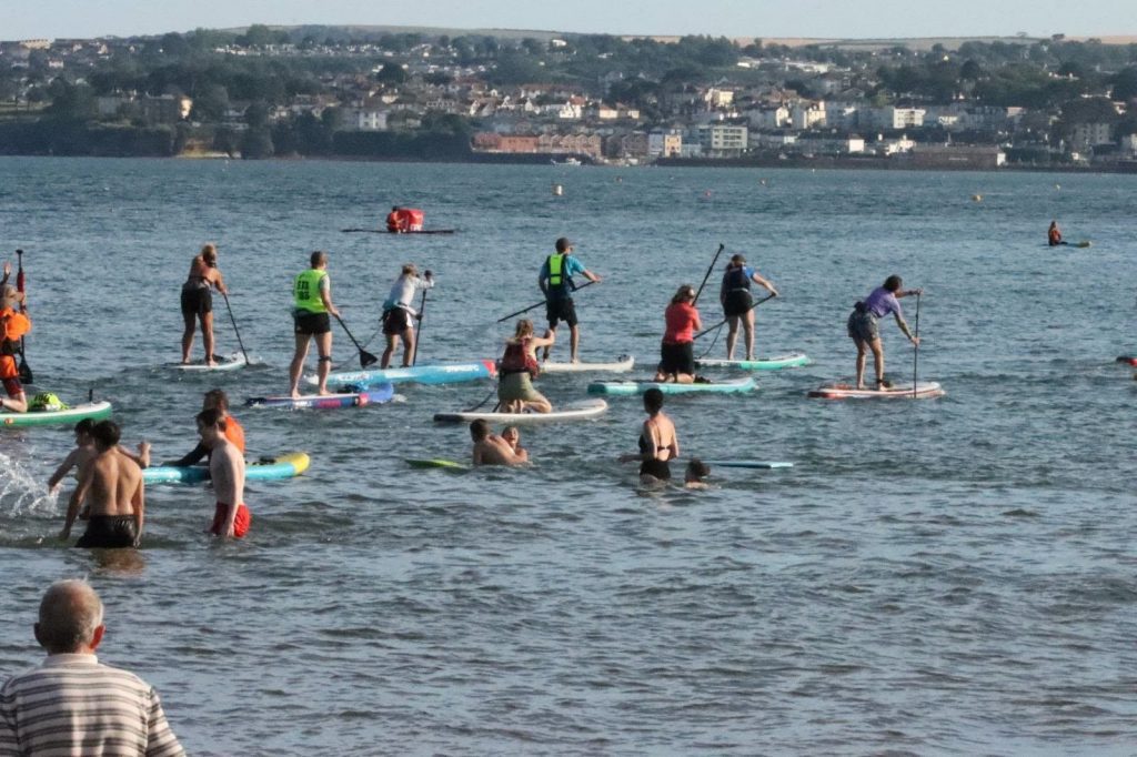 AquaPaddling passed the beach goers